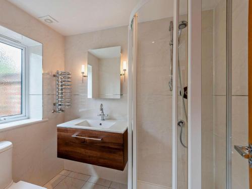 a bathroom with a sink and a shower at 1 Bed in Lymington oc-83370 in Sway