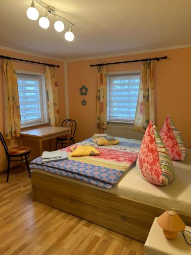 a bedroom with a bed with pillows on it at Bergblick in Saupsdorf