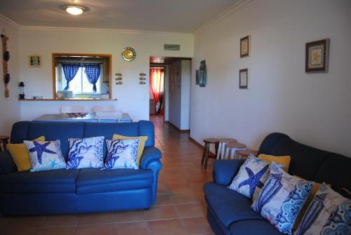 a living room with two blue couches at Vilamoura Apartment in Vilamoura