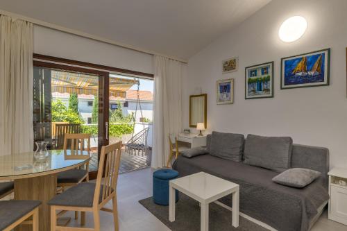 a living room with a couch and a table at Punta Debij Select Apartments in Punat
