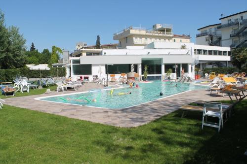 a large swimming pool with people in the water at Terme Villa Pace in Abano Terme