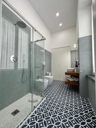 a bathroom with a glass shower and a toilet at I Colori della Bellezza in Gragnano