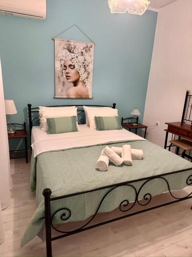 a bedroom with a bed with two towels on it at AnnaPolys House in Kavála