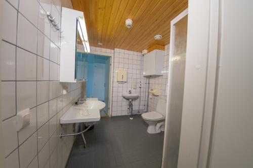 a bathroom with two toilets and a sink at LentoHotelli in Kauhava