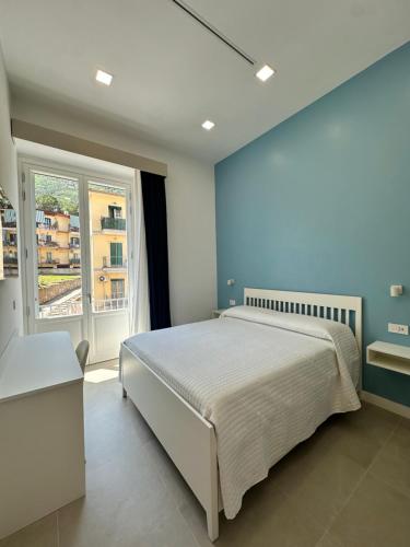 a bedroom with a large bed and a window at I Colori della Bellezza in Gragnano