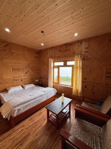 a bedroom with a large bed and a window at Hotel Vishal & Restaurant in Munsyari