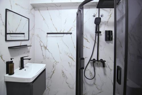 a bathroom with a shower and a sink at RiverSide Apartments in Veles