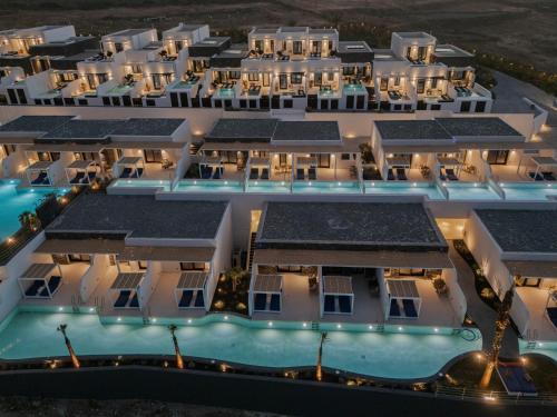 an aerial view of a hotel with solar panels on its roofs at Cresanto Luxury Suites in Imerovigli