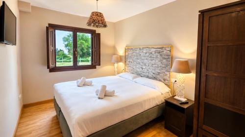 a bedroom with a bed with two towels on it at Villa Los Bufones de Pria in Llames de Pría