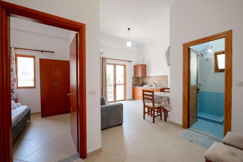 a living room with a door leading to a kitchen at Center Apartments in Ksamil