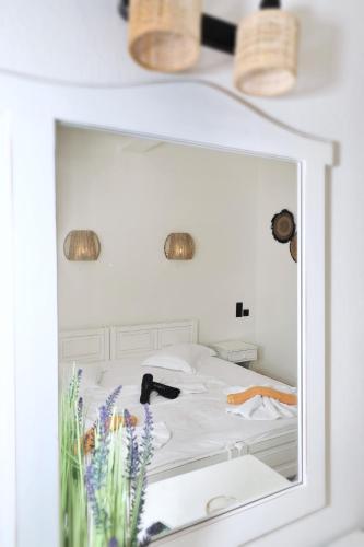 a mirror reflection of a bed in a bedroom at Albatros in Skopelos Town