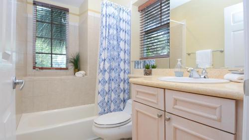 a bathroom with a toilet and a sink and a shower at 612 Mariners Club in Key Largo