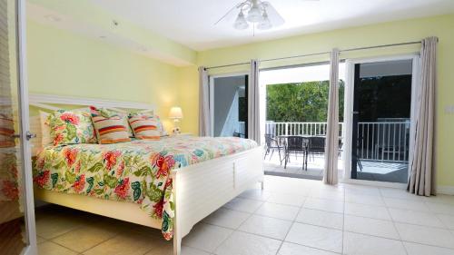a bedroom with a bed and a balcony at 612 Mariners Club in Key Largo