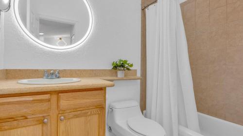 a bathroom with a sink and a toilet and a mirror at 812 Mariners Club in Key Largo