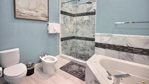 a bathroom with a toilet and a shower and a sink at 808 Mariners Club in Key Largo