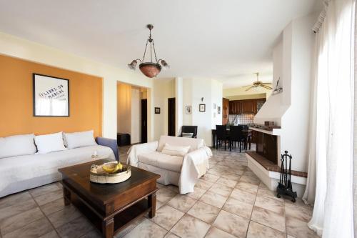 a living room with a couch and a table at Thalia- 2 Bedroom Beachfront Apartment! in Lefokastro