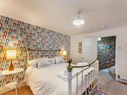 a bedroom with a large bed and a wall of photos at 2 Bed in Brixham oc-bx021 in Brixham