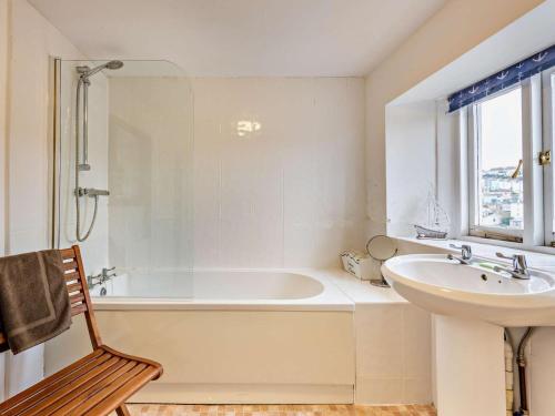 a white bathroom with a tub and a sink at 2 Bed in Brixham oc-bx021 in Brixham