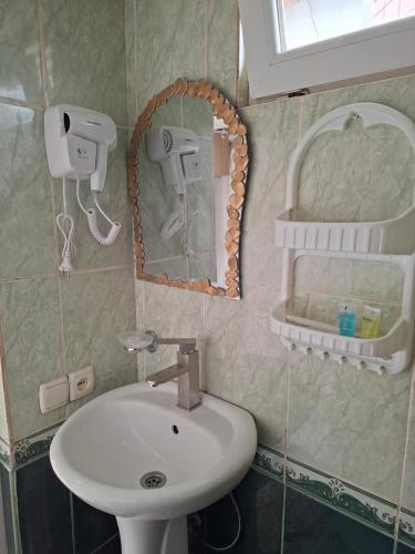 a bathroom with a sink and a mirror at Shorena apartments in Tbilisi City