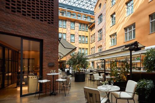 a restaurant with tables and chairs and buildings at Villa Dagmar in Stockholm