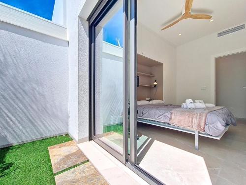 a bedroom with a bed and a sliding glass door at Casa Colisa - 8610 in San Javier