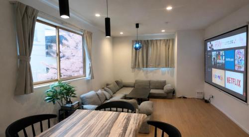 a living room with a couch and a table at Sakura View Nagoya Stay Hub in Nagoya