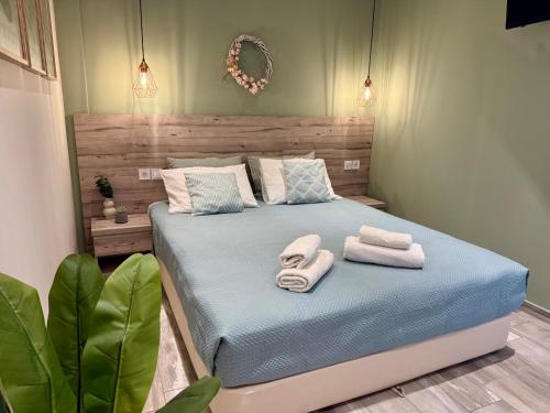 a bedroom with a bed with towels on it at AVLI Sarti Studios & Apartments no2 in Sarti