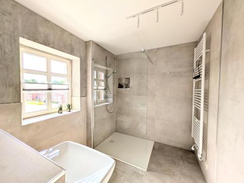 a bathroom with a sink and a toilet and a window at II Bramasole - Sophia L in Spreewitz