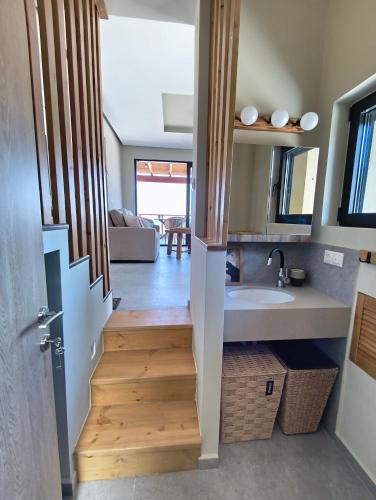 a bathroom with a staircase leading to a kitchen with a sink at my suite home in Heraklio