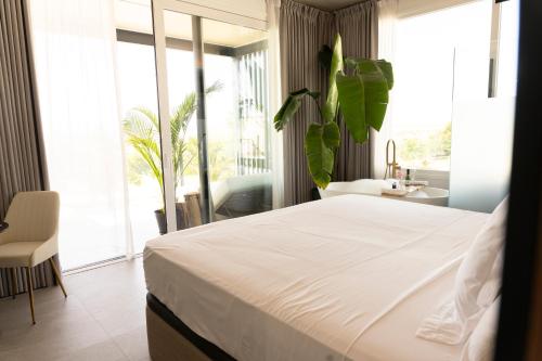 a bedroom with a large bed and a large window at Luxury Experience Suites in Toledo