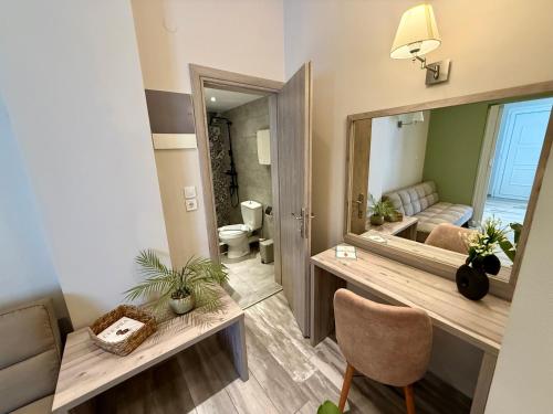 a bathroom with a large mirror and a sink at AVLI Sarti Studios & Apartments no2 in Sarti