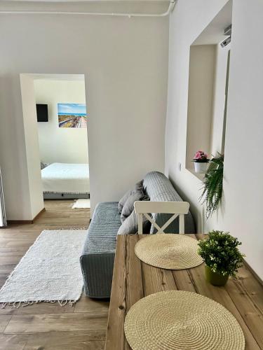a living room with a couch and a table at Borika Vip Apartments in Mezőkövesd