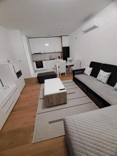 a living room with a couch and a table at Apartman Sunce in Posušje