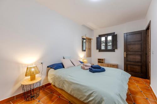 a person laying on a bed in a bedroom at Tu Descanso en Ohanes in Ohanes