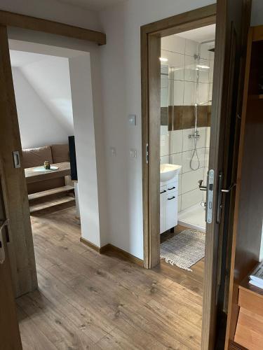 a bathroom with a shower and a sink at Na Młace Apartament z widokiem in Witów