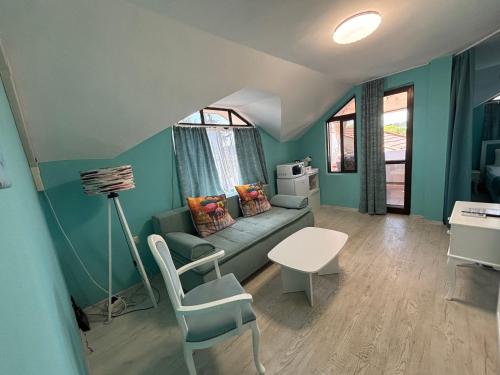 a living room with a couch and a table at Sozopol Romance Apartments in Sozopol