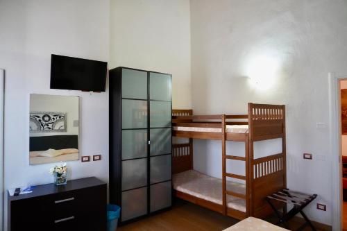 a room with two bunk beds and a tv at La Rosa Garden in Campi Bisenzio