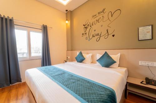 a bedroom with a bed with a sign on the wall at palm hotel mansarovar in Jaipur