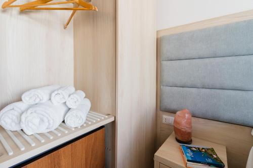 a pile of towels on a shelf in a room at Baia Di Torre Squillace in Sant'Isidoro