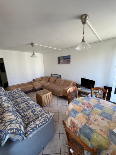 a living room with a couch and a table at Appart 2 ch près RER Champs sur Marne - Disneyland et Paris in Champs-sur-Marne