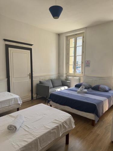 a living room with two beds and a couch at ALBI Chambres in Albi