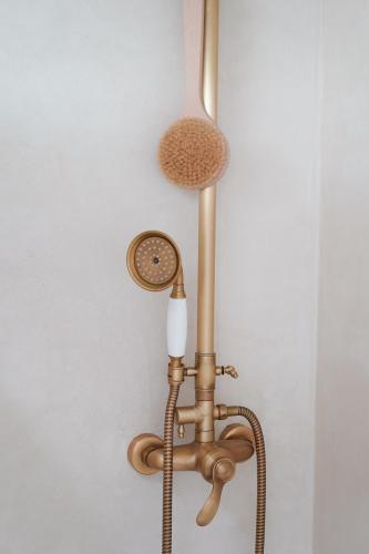 a copper light hanging from a wall at Chambre avec Piscine Maison EtxeCosy in Bidart
