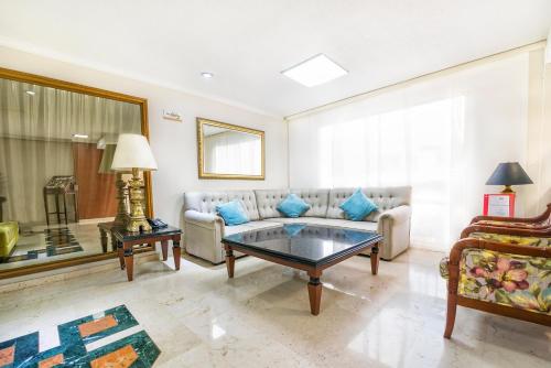 a living room with a couch and a table at Hotel San Pedro del Fuerte in Medellín