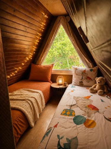 a room with two beds and a window in a tent at Chalet in Le Tholy