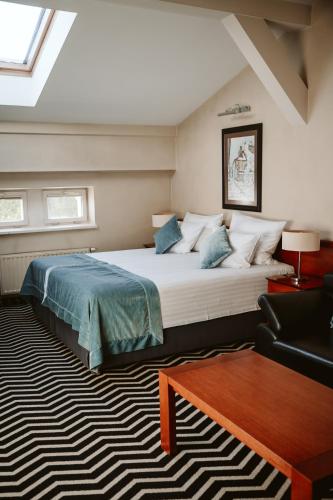 a bedroom with a large bed and a couch at Hotel Senacki in Krakow