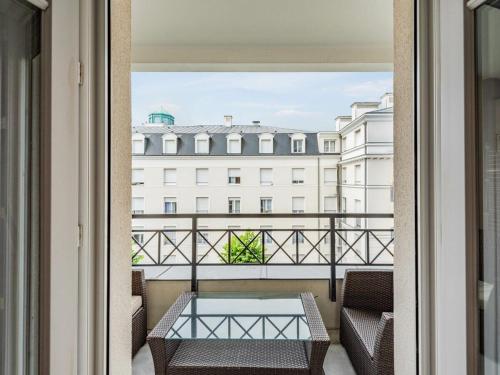 a balcony with a table and a view of a building at Cour Royale Disneyland Paris in Chessy