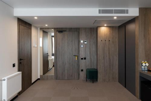 a hallway with a door and a green chair at Житомир by Optima in Zhytomyr