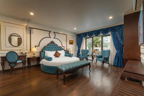 a bedroom with a bed and a desk and chairs at ORA Hotel in Văn La