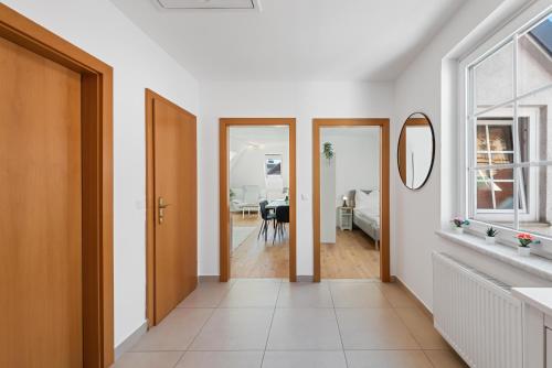 a hallway with doors and a dining room with a table at Stiftblick Residence Melk in Melk