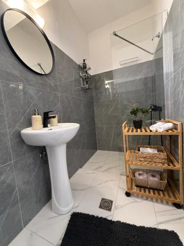 a bathroom with a sink and a mirror at Beachfront Studio with Panoramic Sea View 2 in Ialysos